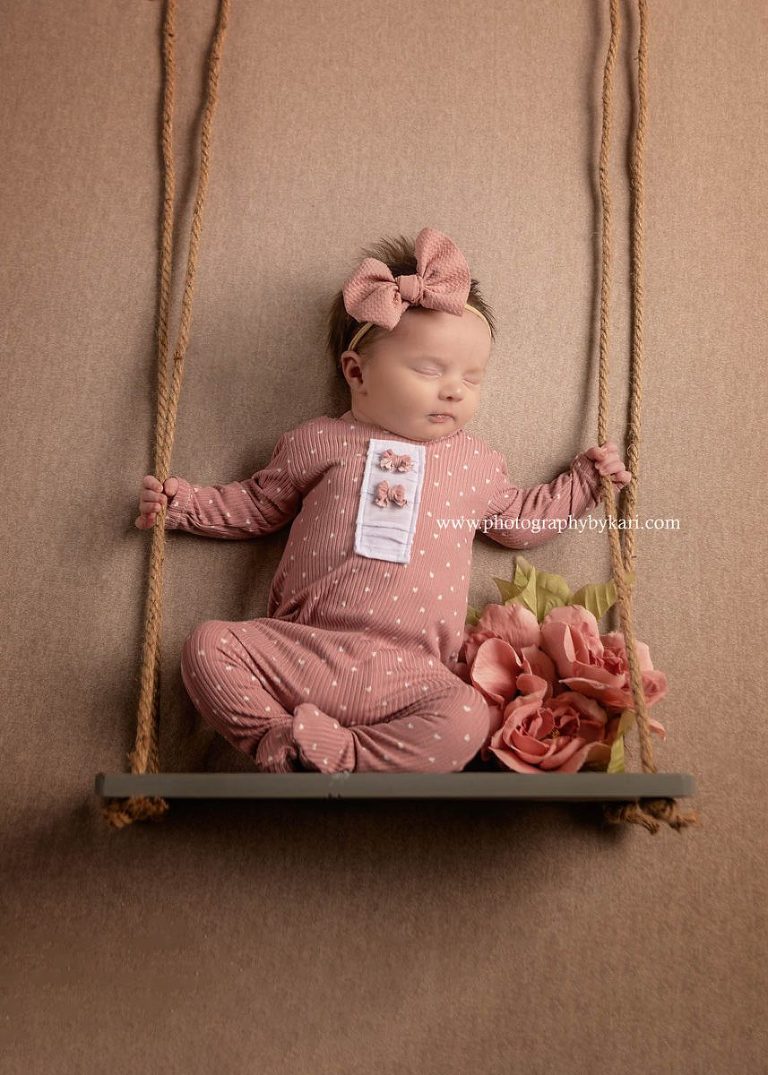 Newborn portrait on swing taken by Photography by Kari
